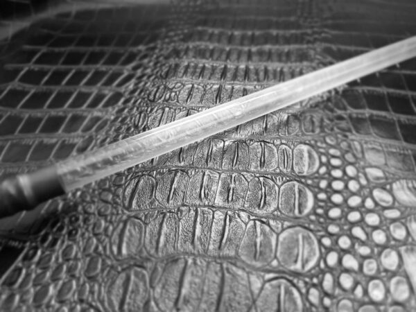 Clear acrylic rod against alligator faux leather