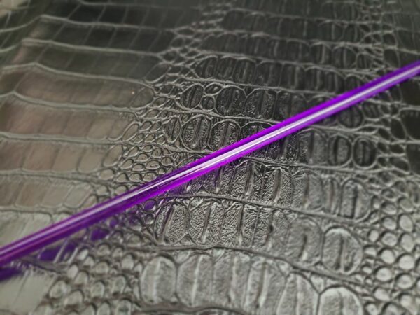 Purple acrylic rod against alligator faux leather